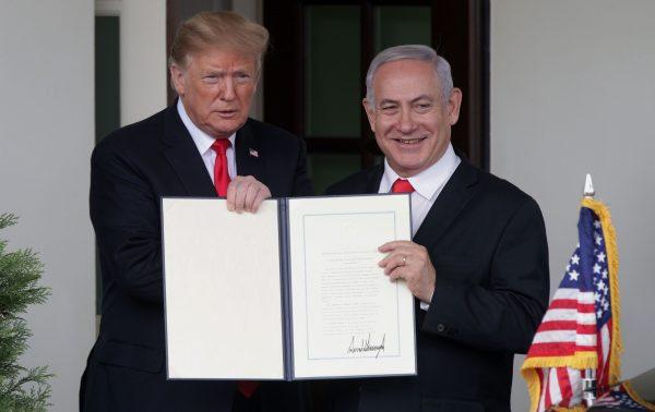 Then-President Donald Trump (L) and then-Prime Minister of Israel Benjamin Netanyahu show the proclamation recognizing Israel’s sovereignty over Golan Heights after a meeting outside the West Wing of the White House on March 25, 2019. (Alex Wong/Getty Images)
