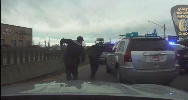 Officers shift out of the way of the vehicle on I-77, Cleveland, Ohio, on March 22, 2019. (Ohio State Highway Patrol)