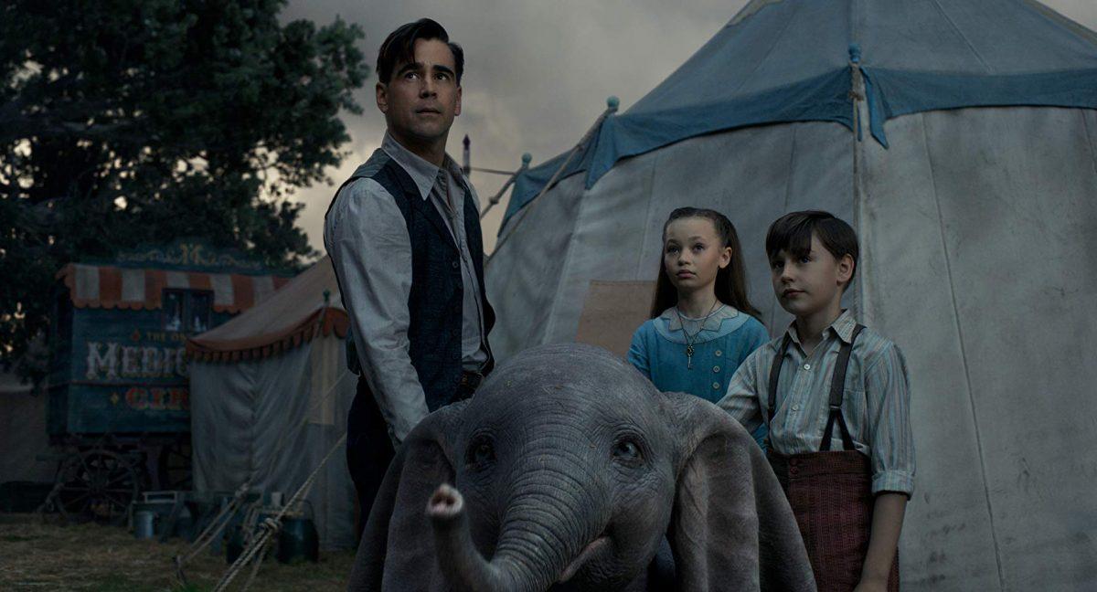 Holt Farrier (Colin Farrell, L), Milly Farrier (Nico Parker), and Joe Farrier (Finley Hobbins) become Dumbo’s caretakers in the Medici Bros. Circus, in "Dumbo." (Walt Disney Studios)