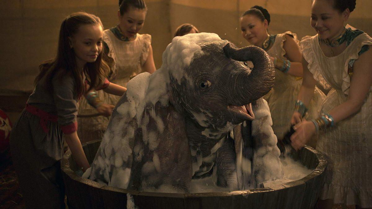 Milly (Nico Parker, L) gives baby elephant Dumbo a bubble bath in "Dumbo." (Walt Disney Studios)