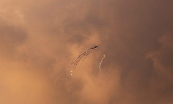 An Israeli Apache helicopter releases flares as it flies over the Gaza Strip March 25, 2019. (Mohammed Ajour/Reuters)