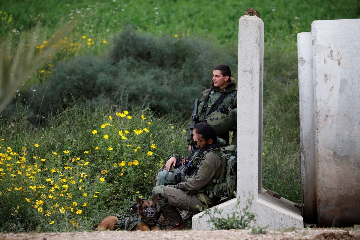 Israeli soldiers lean against a concrete barrier block near the border with Gaza, in southern Israel March 25, 2019. (Amir Cohen/Reuters)