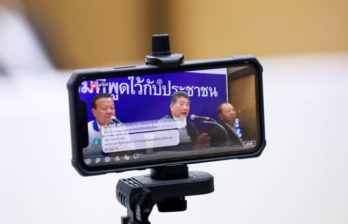 Phumtam Wechayachai, Secretary General of Pheu Thai party, is seen on a screen as he talks during a news conference in Bangkok, Thailand, on March 26, 2019. (Soe Zeya Tun/Reuters)