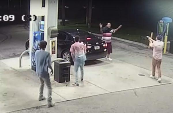 The would-be-robber holds his hands up as one of the cousins turns his own gun on him. (Broward County Sheriff)