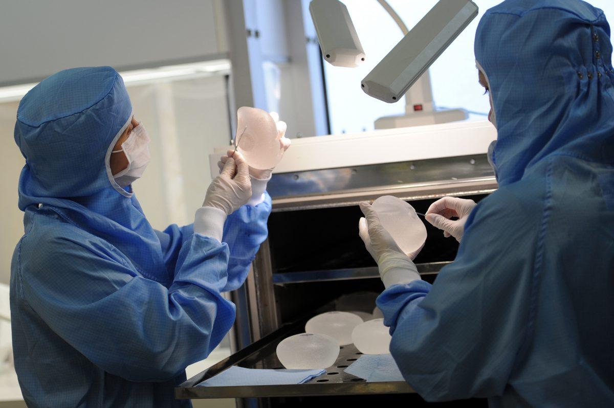 Technicians checking silicone breast implants at the end of the oven process in Paris, France, on Jan. 12, 2012. (Miguel Medina/AFP/Getty Images)