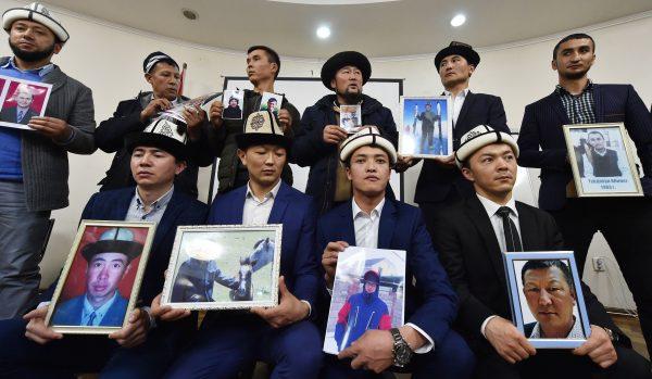 Kyrgyz men hold portraits of relatives they fear are being held in “reeducation camps” in China’s Xinjiang region, at a press conference in Bishkek, Kyrgyzstan, on Nov. 29, 2018. (Vyacheslav Oseledko/AFP/Getty Images)