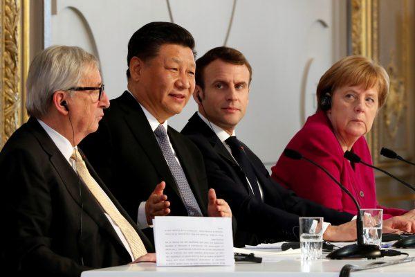 French President Emmanuel Macron, Chinese leader Xi Jinping, German Chancellor Angela Merkel, and European Commission President Jean-Claude Juncker hold a news conference at the Elysee presidential palace in Paris on March 26, 2019. (Thibault Camus/Pool via Reuters)