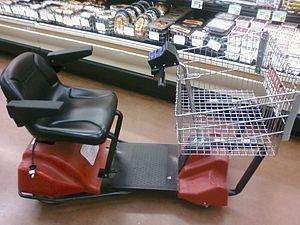 A motorized shopping cart in a supermarket (Public Domain)