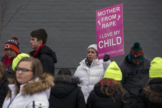 Yoi Reyes of Mary's Pregnancy Resource Center in Fort Lauderdale, Florida, holds a sign during a protest vigil in Washington, on Jan. 17, 2019. (Zach Gibson/Getty Images)