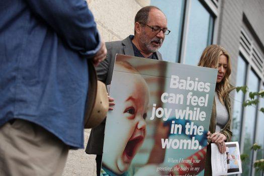 Rev. Patrick Mahoney (C), national director of the Christian Defense Coalition, prays with Stanton Healthcare Founder and CEO Brandi Swindell (R) outside Planned Parenthood Carol Whitehill Moses Center in Washington, on May 5, 2017. (Alex Wong/Getty Images)