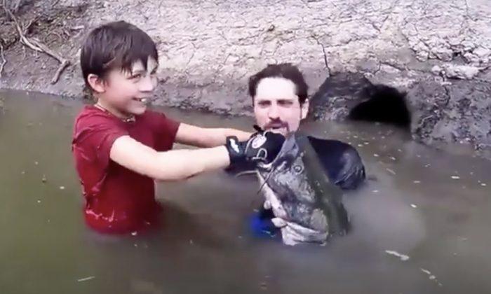Dad Asks Son to Lower Arm Into Dark Hole Only to Pull Out a Monster Fish As Big As Him