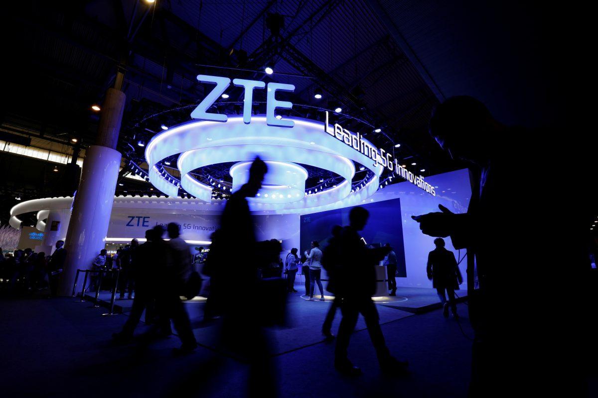 People walk next to ZTE booth at the Mobile World Congress in Barcelona, Spain, on Feb. 25, 2019. (Rafael Marchante/Reuters)