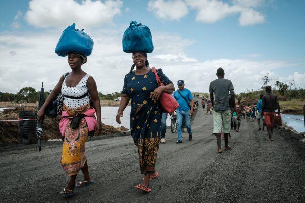 People walk on a re-constructed road after the original road was destroyed by the cyclone Idai in John Segredo, on March 24, 2019. (Yasuyoshi Chiba/AFP/Getty Images)