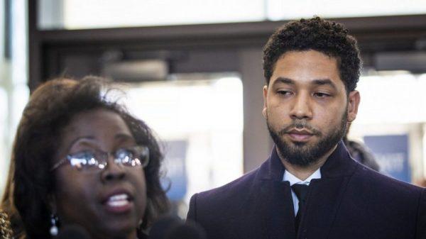 Actor Jussie Smollett (R), listens as his attorney, Patricia Brown Holmes, speaks to reporters at the Leighton Criminal Courthouse after prosecutors dropped all charges against him, on March 26, 2019. (Ashlee Rezin/Sun-Times/Chicago Sun-Times via AP)