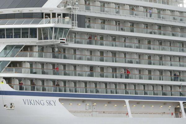 Some of the remaining passengers look out as the cruise ship Viking Sky arrives at port off Molde, Norway, on March 24, 2019. (Svein Ove Ekornesvag/NTB scanpix via AP)