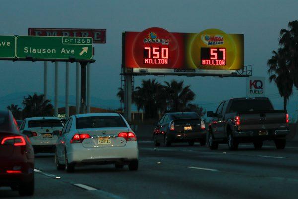 A highway billboard promoting the current Powerball jackpot lottery reaches out to commuters in Los Angeles, on March 26, 2019. (Mike Blake/Reuters)