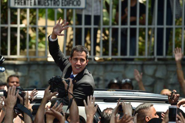 Juan Guaido, recognized by more than 50 countries as Venezuela’s legitimate interim president, waves to supporters during a rally with local and regional leaders in Caracas on March 27, 2019. (Yuri Cortez/AFP/Getty Images)