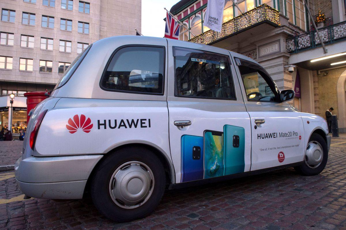 A London taxi carrying advertising for Chinese technology giant Huawei waits outside Charing Cross railway station in central London on Dec. 27, 2018. (Niklas Halle'n/AFP/Getty Images)