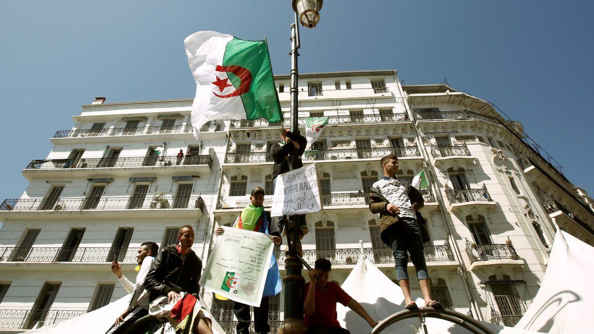 People carry national flags during a protest to demand the removal of President Abdelaziz Bouteflika in Algiers, Algeria on March 29, 2019. (Ramzi Boudina/Reuters)