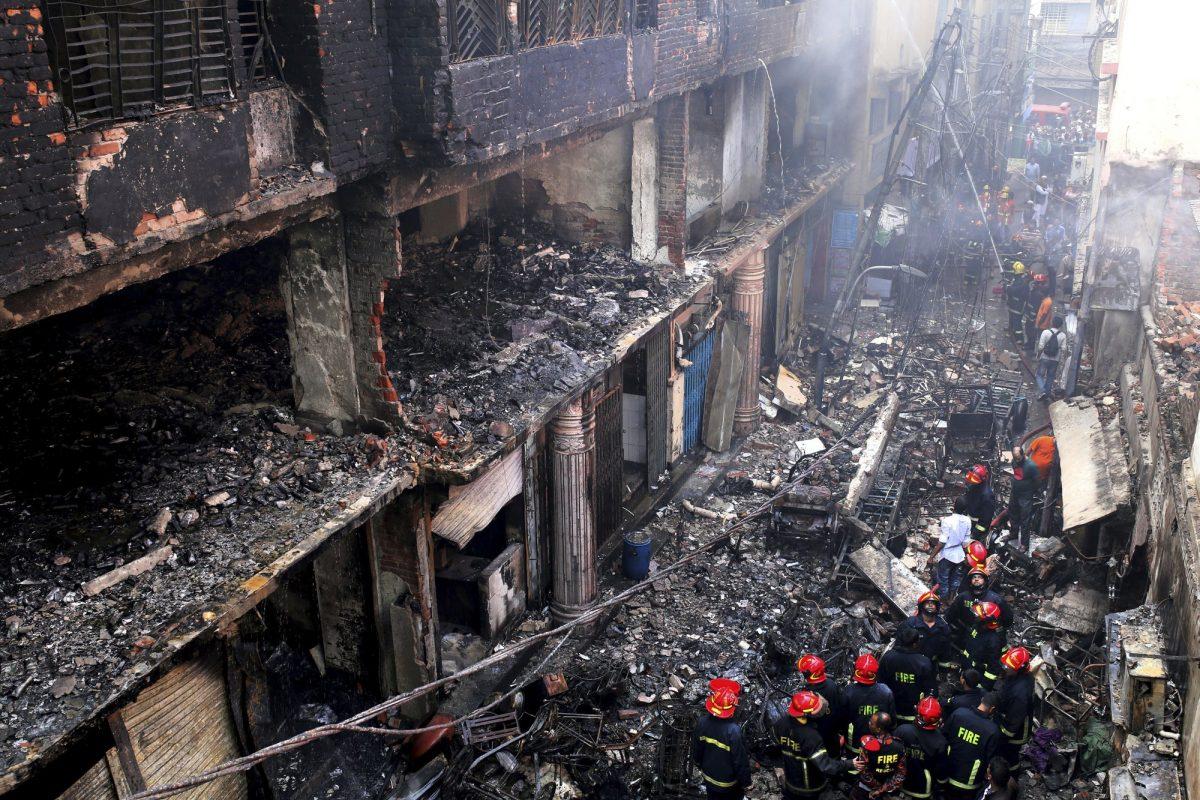 Locals and firefighters gather around buildings that caught fire on Feb. 20 in Dhaka, Bangladesh, on Feb. 21, 2019. (Rehman Asad, File/AP Photo)