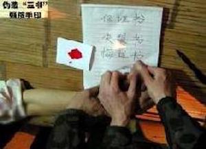 Falun Gong practitioners are forced to sign a document with their fingerprint to show that they have renounced their faith . (Minghui.org)