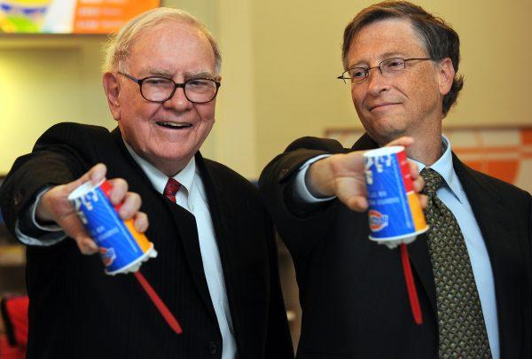 US billionaire investor Warren Buffett, CEO of Berkshire Hathaway which owns Dairy Queen (L) and Microsoft founder Bill Gates (R) flip over their Dairy Queen Blizzard treats in Beijing, China on Sept. 30, 2010. (Frederic J. Brown/AFP/Getty Images)