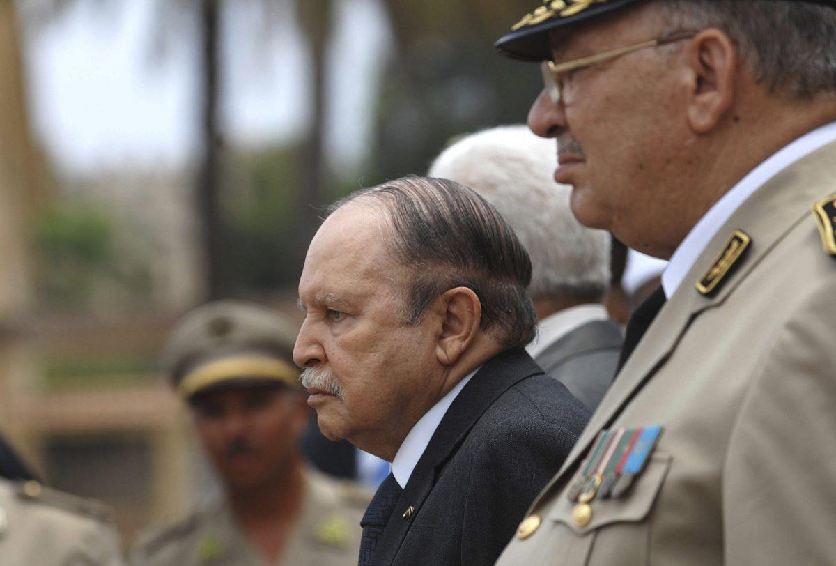 Algerian President Abdelaziz Bouteflika, left, and his Army chief of staff, Gen. Ahmed Gaid Salah, review an honor guard before attending a military parade, in Cherchell near Algiers, Algeria on June 27, 2012. (Anis Belghoul/AP Photo)