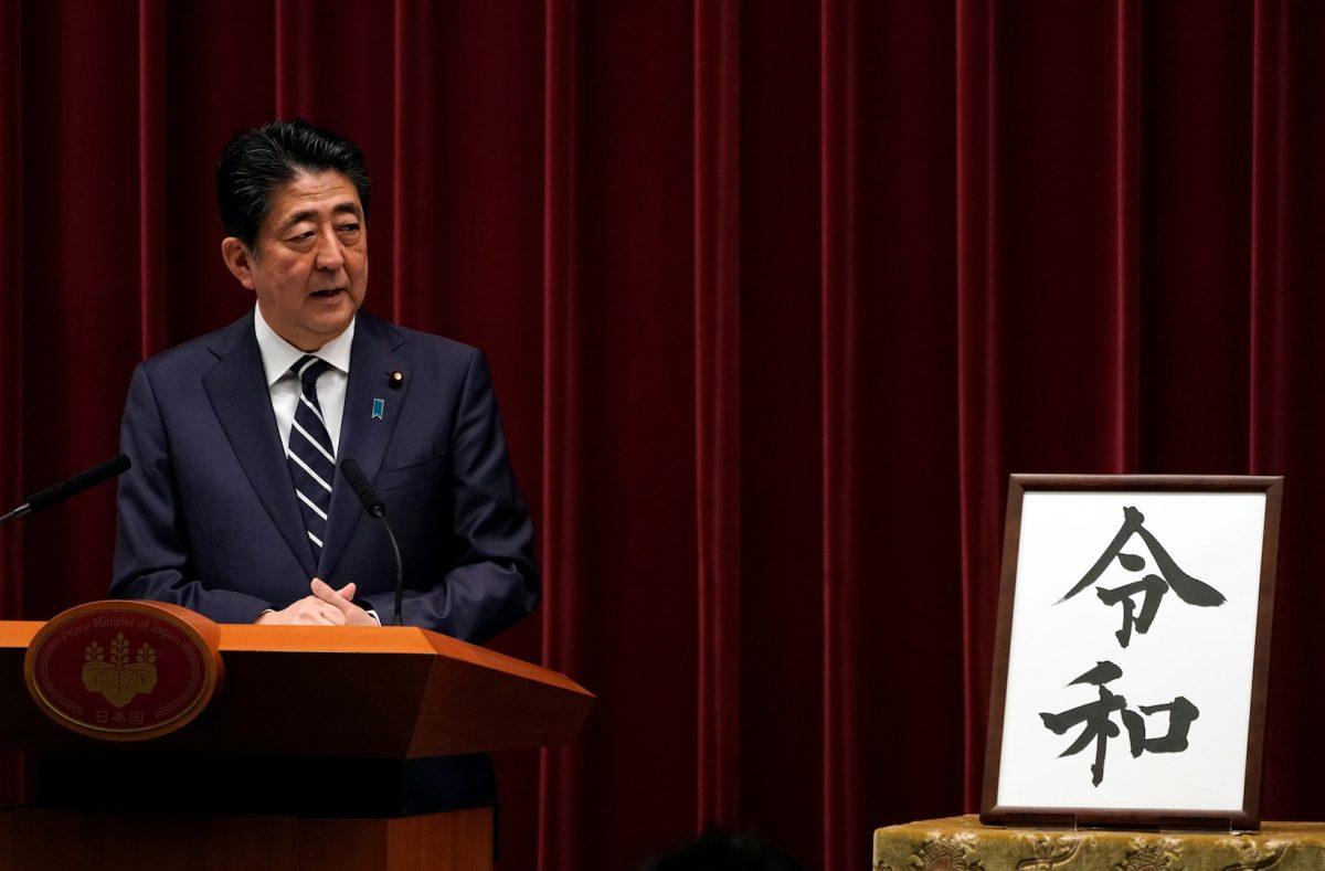 Japan's Prime Minister Shinzo Abe delivers a press conference standing next to the calligraphy 'Reiwa' which was chosen as the new era name at the prime minister's office in Tokyo, Japan, on April 1, 2019. (Franck Robichon/Pool via Reuters)