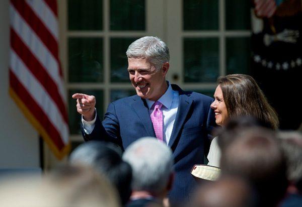 Supreme Court Justice Judge Neil Gorsuch points as his wife Marie Louise Gorshuch looks on during a ceremony in the Rose Garden at the White House in Washington, on April 10, 2017. (Eric Thayer/Getty Images)