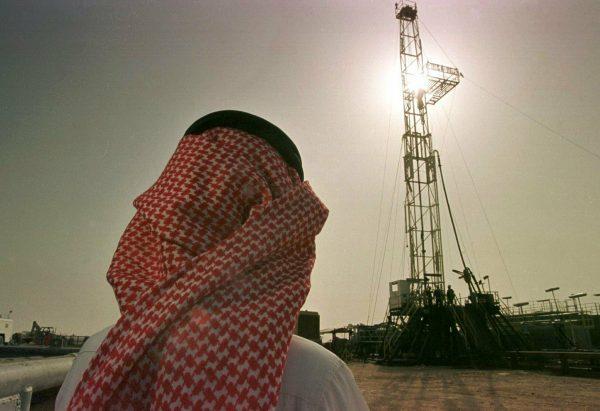 Khaled al-Otaiby, an official of the Saudi oil company Aramco, watches progress at a rig at the al-Howta oil field near Howta, Saudi Arabia on Feb. 26, 1997. (John Moore/AP)