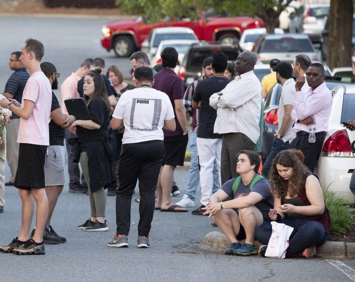 People gather across from the campus of UNC Charlotte after a shooting incident at the school in Charlotte, N.C., on April 30, 2019. (Jason E. Miczek/AP Photo)
