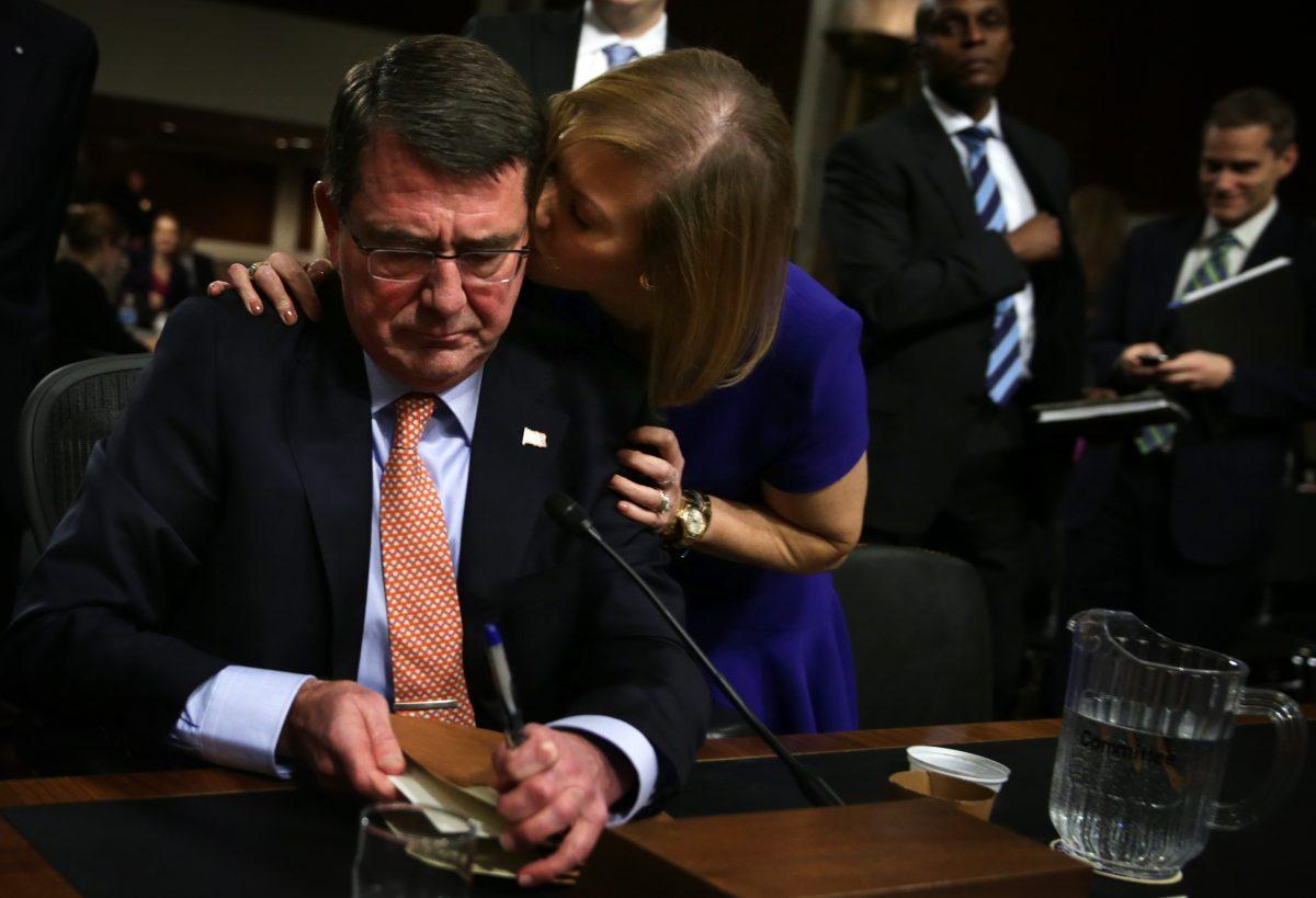 Former Deputy Secretary of Defense Ashton Carter (L) is kissed by his wife Stephanie at the end of his confirmation hearing before the Senate Armed Services Committee, on Feb. 4, 2015, on Capitol Hill in Washington. (Alex Wong/Getty Images)