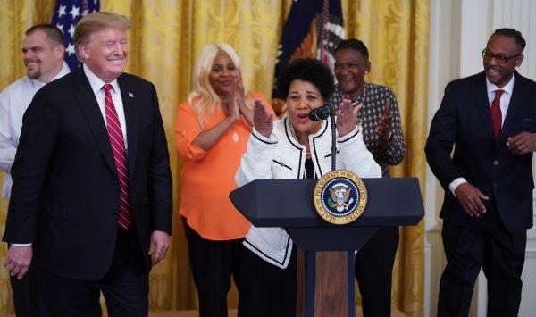 Alice Marie Johnson, who had her sentence commuted by U.S. President Donald Trump (L) after serving 21 years in prison for cocaine trafficking, thanks the press during a celebration of the First Step Act in the East Room of the White House on April 1, 2019. (Chip Somodevilla/Getty Images)