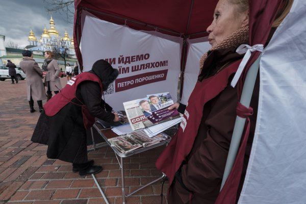 Canvassers for Ukrainian President Petro Poroshenko’s re-election campaign hand out flyers in central Kiev on March 31, 2019. (Chris Collison for The Epoch Times)