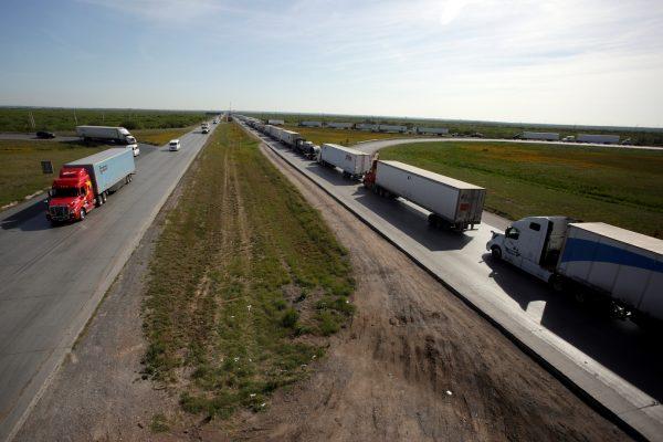 Trucks wait in a long queue for border customs control to cross into the United States at the World Trade Bridge in Nuevo Laredo, Mexico, on April 2, 2019. (Daniel Becerril/Reuters)