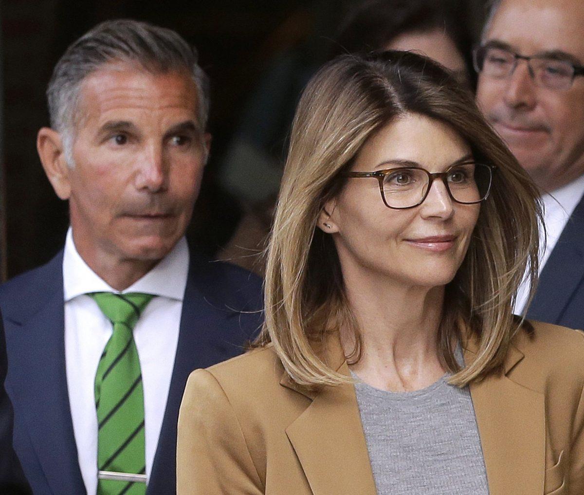 Actress Lori Loughlin, front, and husband, clothing designer Mossimo Giannulli, left, depart federal court in Boston on April 3, 2019. (Steven Senne/Photo via AP)