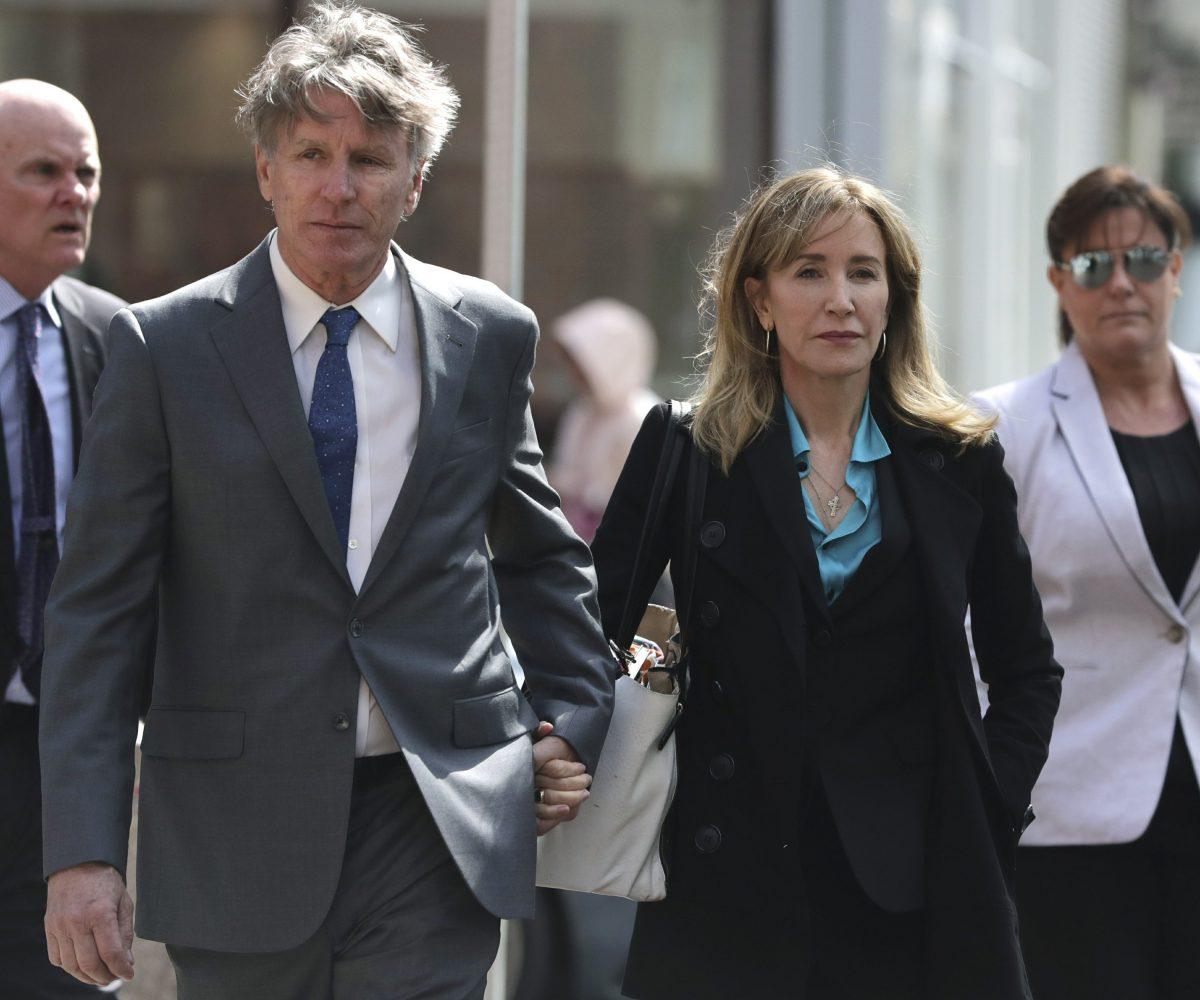 Actress Felicity Huffman arrives holding hands with her brother, Moore Huffman Jr., left, at federal court in Boston on April 3, 2019. (Charles Krupa/Photo via AP)