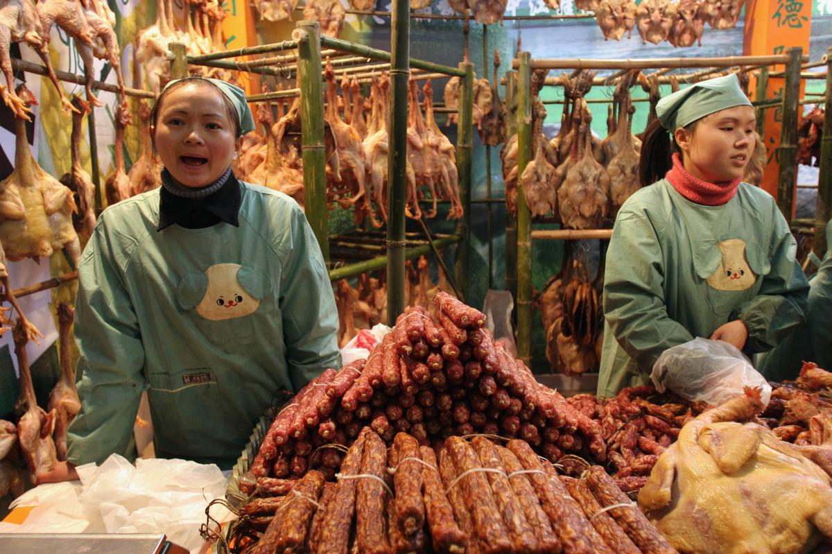 Vendors sell preserved food at a market in Chengdu of Sichuan Province, China on Jan. 23, 2005. China made pork products were detected African swine fever virus in several countries. (China Photos/Getty Images)