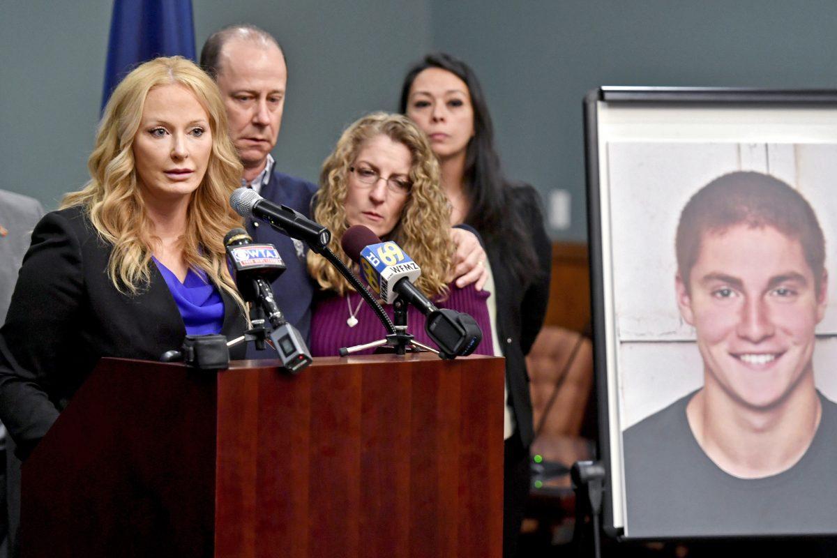 Jim and Evelyn Piazza stand by as Centre County District Attorney Stacy Parks Miller, left, announces the results of an investigation into the death of their son Timothy Piazza, seen in photo at right, a Penn State University fraternity pledge, during a press conference in Bellefonte, Pa., on May 5, 2017. (Abby Drey/Centre Daily Times via AP)