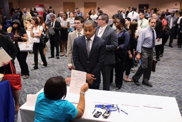 Job applicants line up to meet potential employers at a job fair in N.Y. on June 11, 2012. (John Moore/Getty Images)