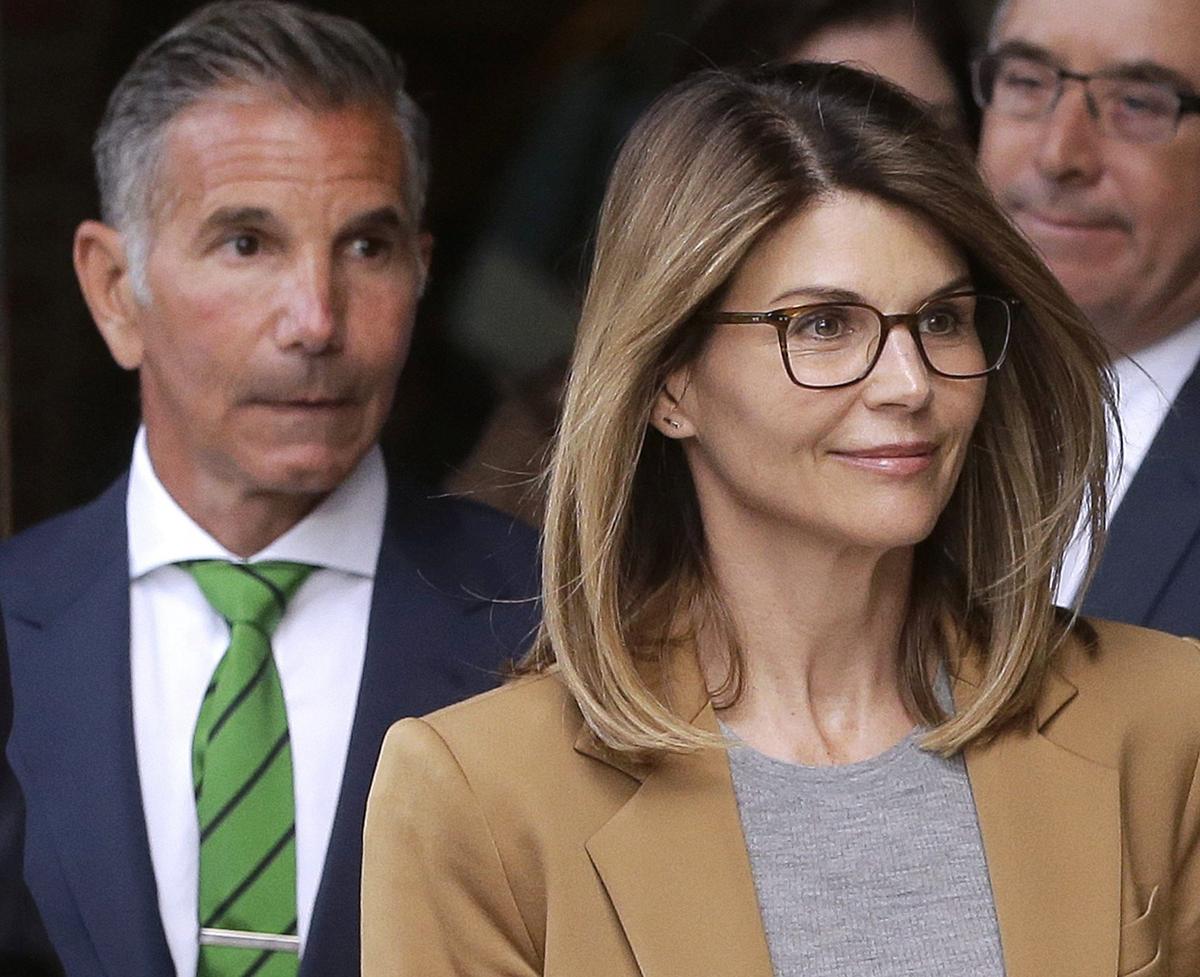 Actress Lori Loughlin (front) and husband, clothing designer Mossimo Giannulli depart federal court in Boston on April 3, 2019. (Steven Senne/AP Photo)