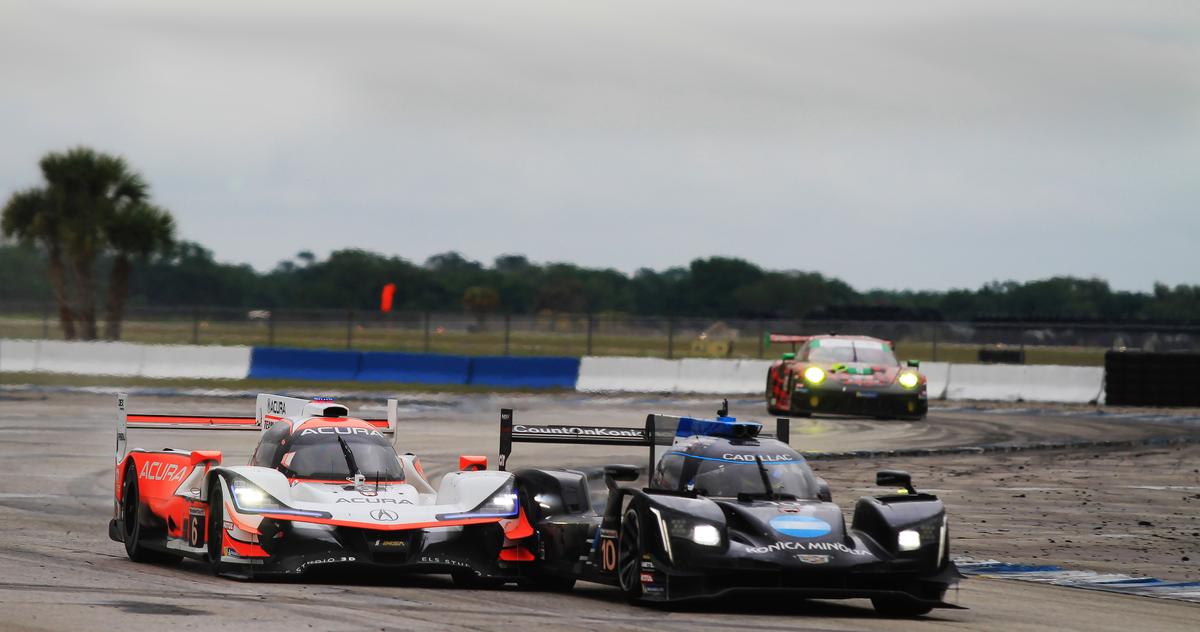  The #6 Acura and #10 WTR Cadillac battle for position around Turn 15 a few hours into the race. (Chris Jasurek/Epoch Times)