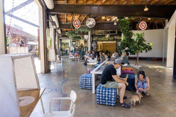 Rest spaces complete with swinging benches invite shoppers to slow down and hang out. (Crystal Shi/The Epoch Times)