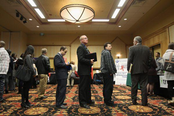 Job applicants wait in line to meet potential employers at the "Denver Hires Job Fair" in Denver, Colo. on Dec. 5, 2011. (John Moore/Getty Images)