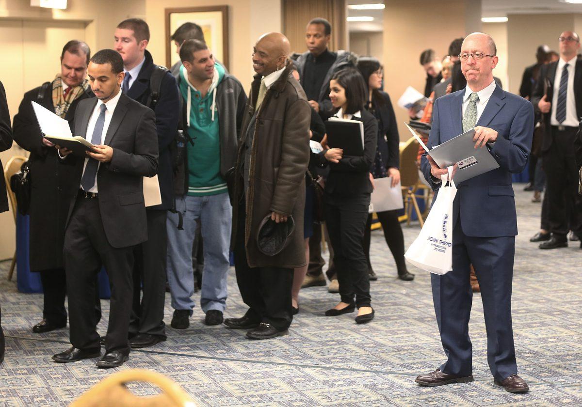 Applicants wait to meet potential employers at a Manhattan job fair in N.Y. on Jan. 17, 2013. (Mario Tama/Getty Images)
