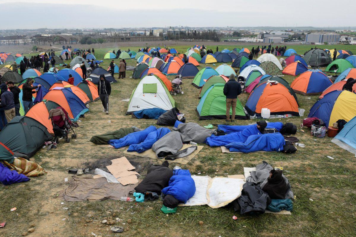 Migrants and refugees, who say that they seek to travel onward to northern Europe sleep outside a camp in the town of Diavata, Greece, on April 5, 2019. (Alexandros Avramidis/Reuters)
