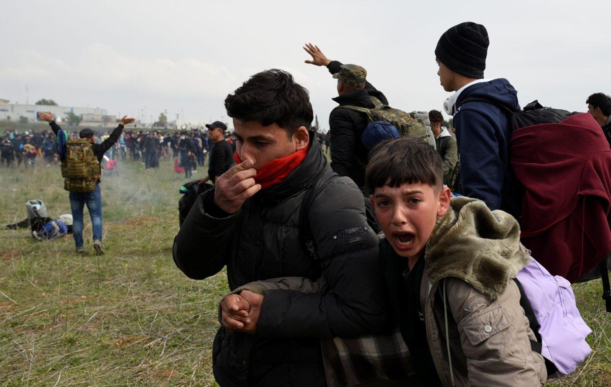 A boy cries as migrants and refugees, who say that they seek to travel onward to northern Europe, walk away from a camp near the town of Diavata in northern Greece, on April 5, 2019. (Alexandros Avramidis/Reuters)