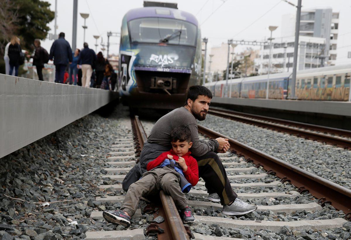 Migrants and refugees, who say that they seek to travel onward to northern Europe, sit on railway tracks during a protest at main railway station in Athens, Greece, on April 5, 2019. (Costas Baltas/Reuters)