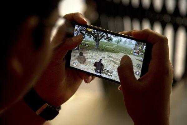 An Indian boy plays an online game PUBG on his mobile phone in Hyderabad, India, on April 5, 2019. (Mahesh Kumar A/Photo via AP)