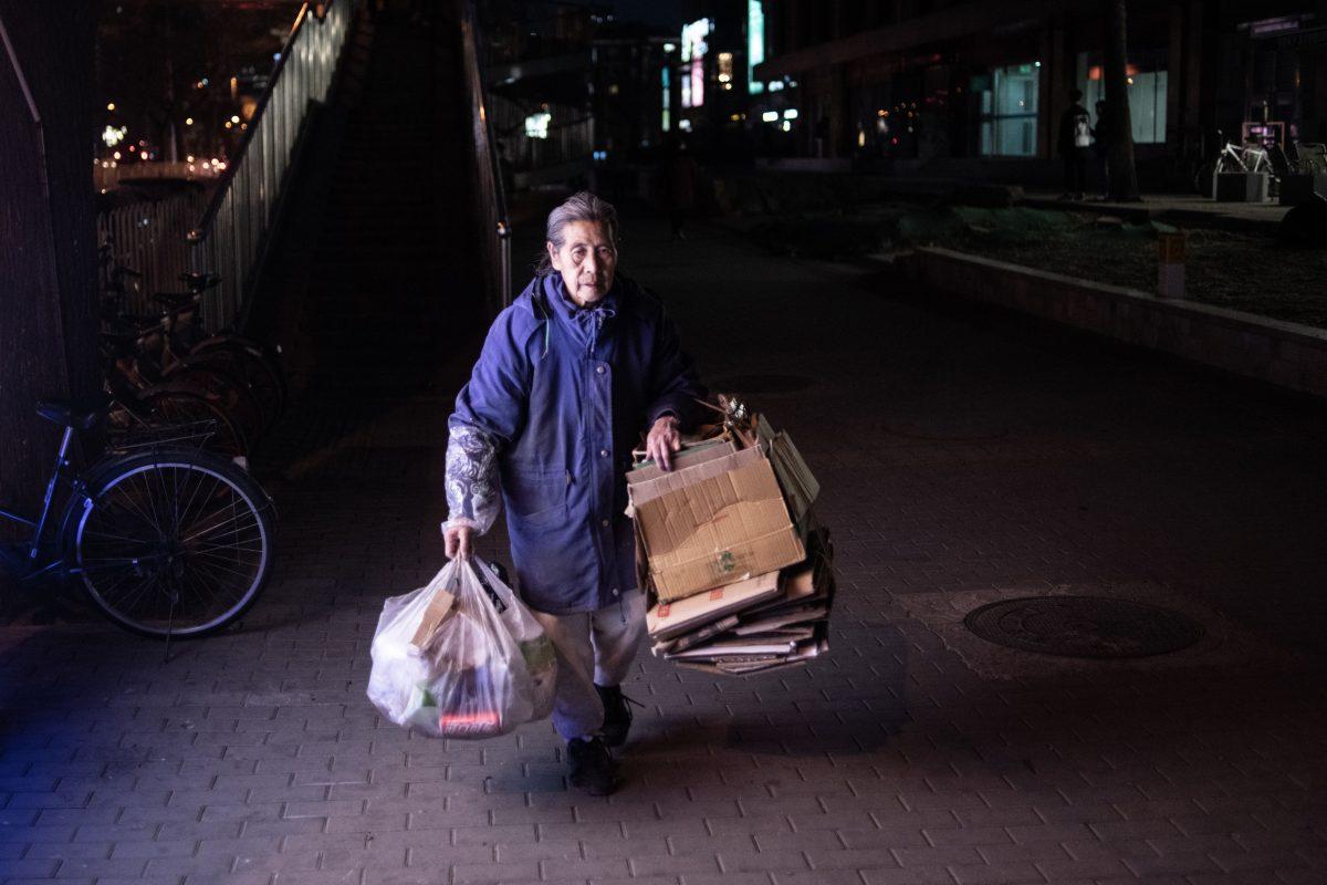 An elderly woman collects plastic and paper in Beijing on March 14, 2019. (Fred Dafour/AFP/Getty Images)